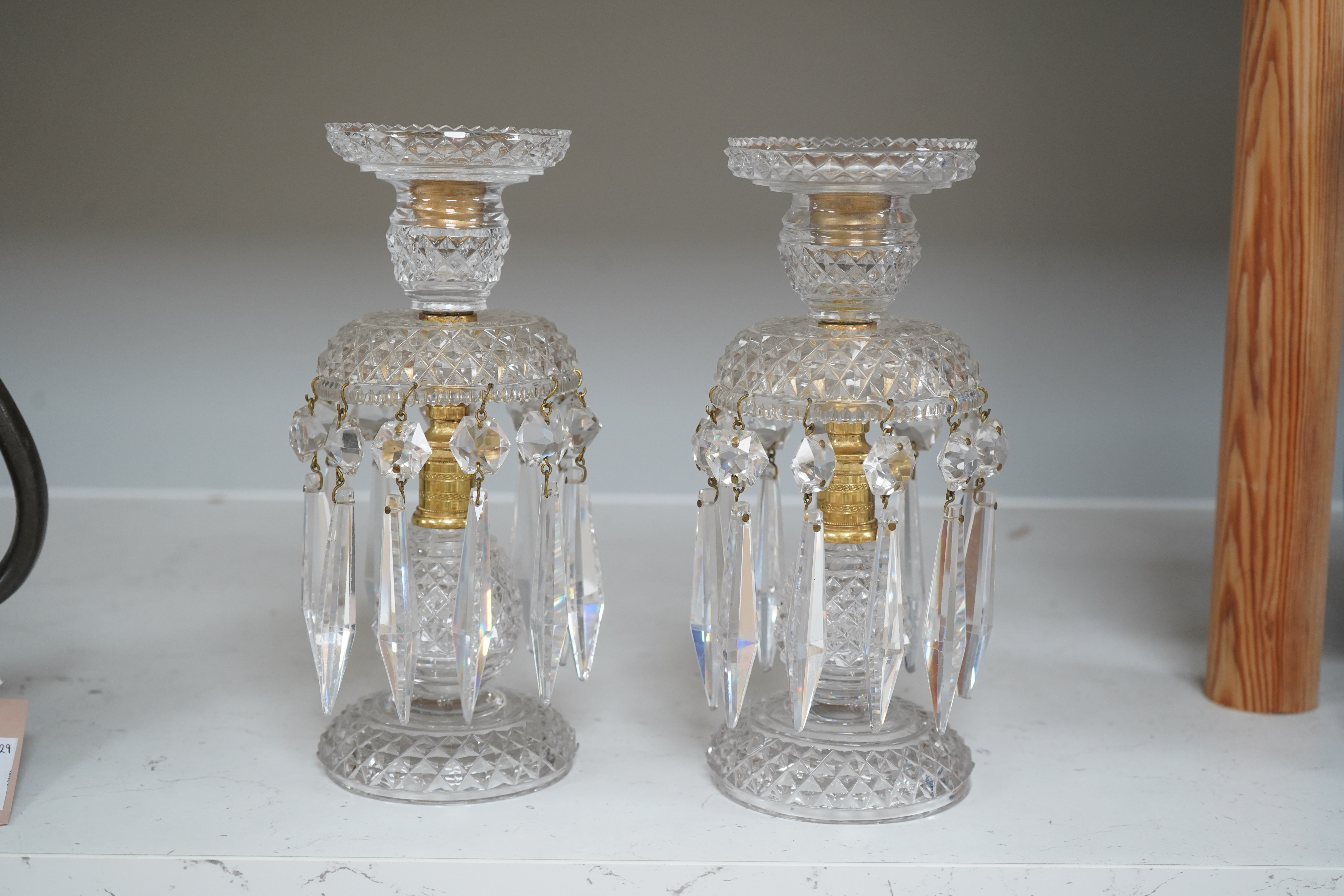 A pair of Victorian cut glass and gilt metal table lustres, 21.5cm. Condition- minor nicks